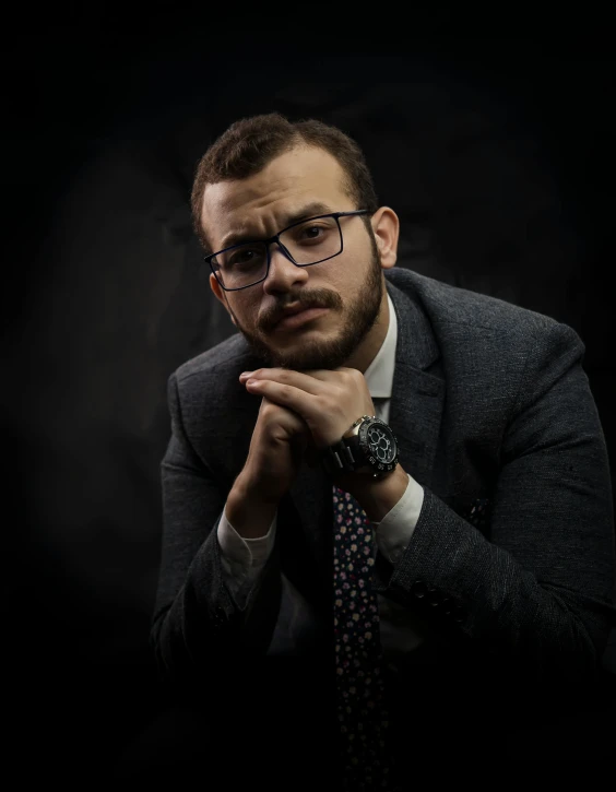 a man in a suit and tie posing for a picture, a character portrait, by Ismail Acar, pexels contest winner, twitch streamer / gamer ludwig, ( low key light ), myserious man, lgbtq