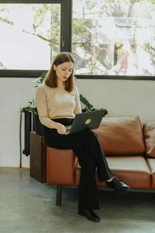 a woman sitting on a couch using a laptop, wearing business casual dress, sit on a bench, 2019 trending photo, profile image