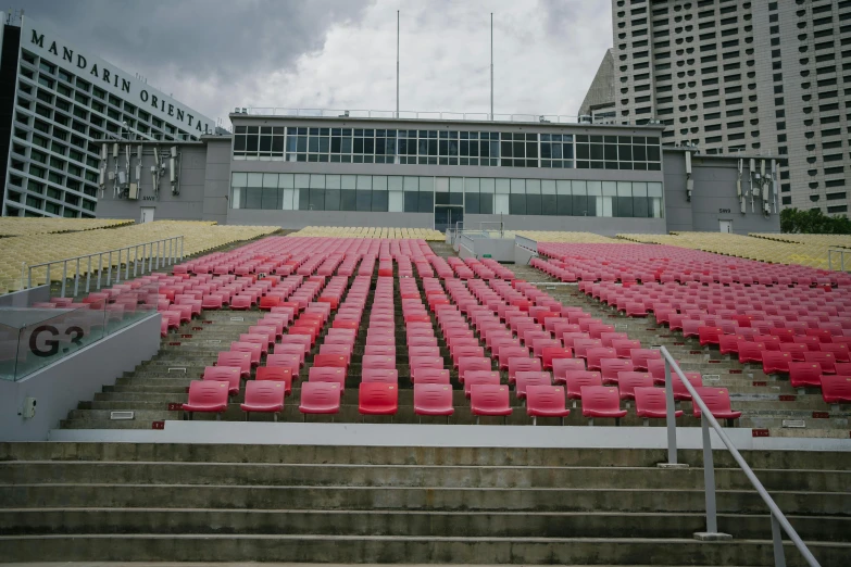 a stadium filled with lots of red seats, by Aguri Uchida, temporary art, gray, square, pitt, high quality photo