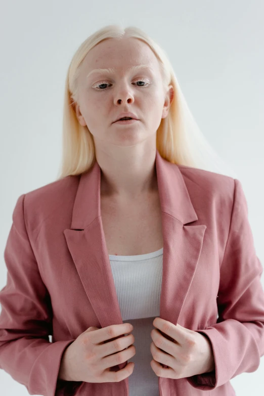 a woman with blonde hair wearing a pink blazer, inspired by Louisa Matthíasdóttir, trending on pexels, renaissance, scared expression, albino, vocal tract model, leaked photo