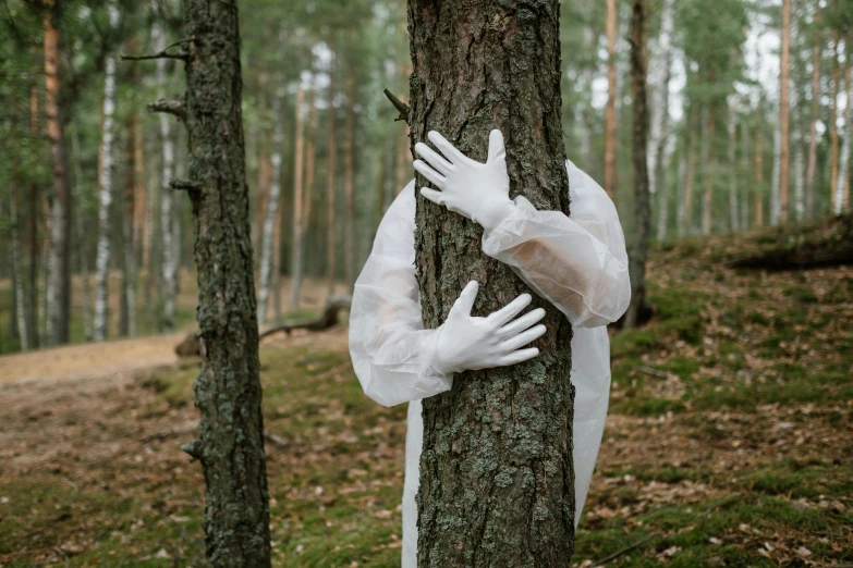 a person wrapped in plastic leaning against a tree, inspired by Elsa Bleda, pexels contest winner, environmental art, white long gloves, political meeting in the woods, zentai suit, hunting