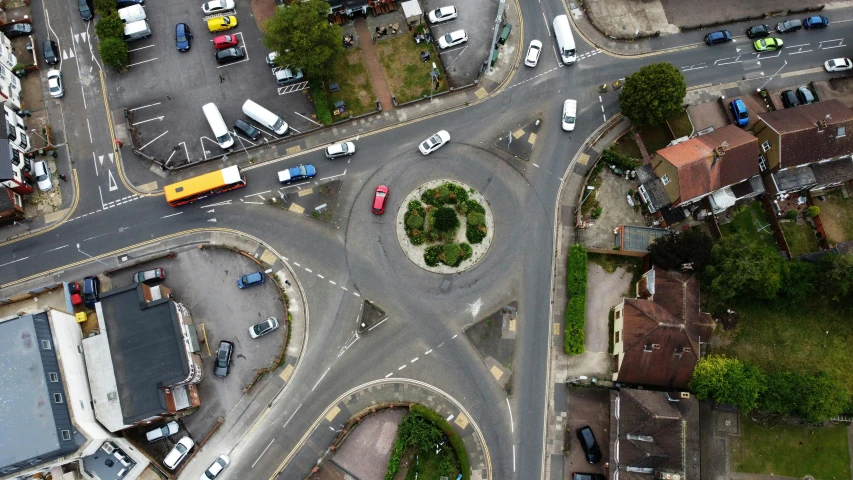 a bird's eye view of a city intersection, by Tom Bonson, unsplash, photorealism, esher, circle pit, paisley, vehicle