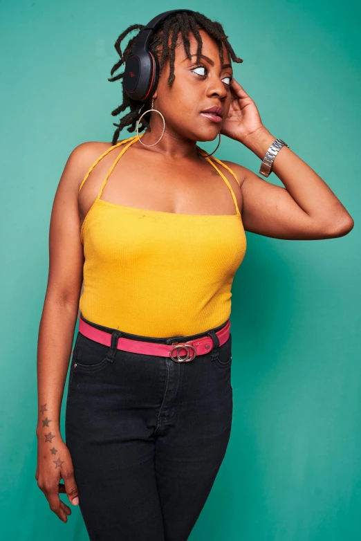 a woman talking on a cell phone while wearing headphones, an album cover, by Ella Guru, wearing yellow croptop, full view blank background, promo image, curvy figure