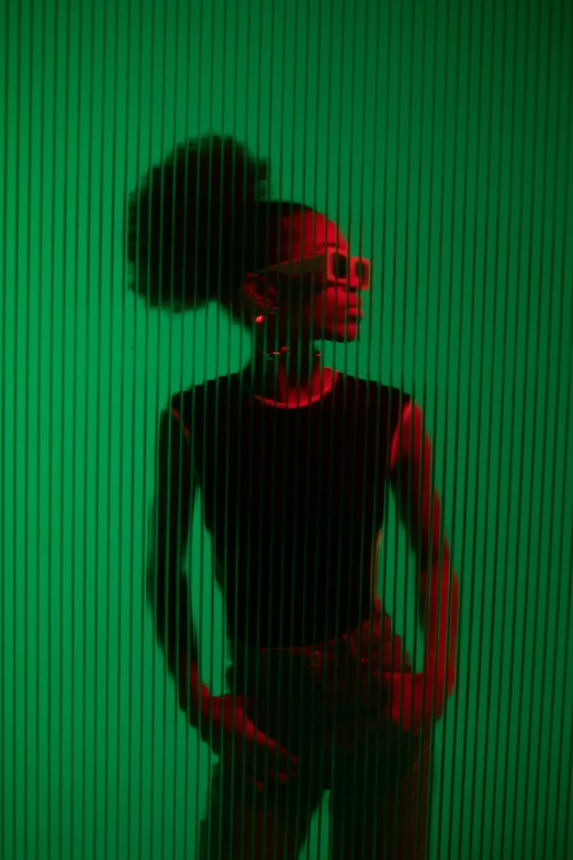 a woman standing in front of a green wall, inspired by Carrie Mae Weems, pexels contest winner, afrofuturism, neon backlit, transparent glass woman, album art young thug, symmetric portrait