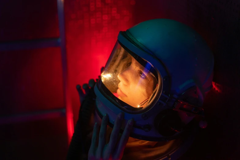 a close up of a person in a space suit, an album cover, inspired by Elsa Bleda, pexels contest winner, red and cinematic lighting, miss aniela, tv show still, helmet view