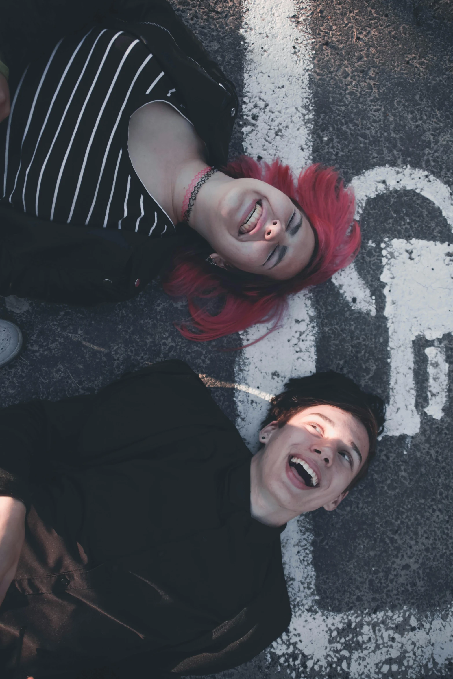 a group of people standing next to each other on a street, an album cover, pexels contest winner, antipodeans, bright red hair, laying on their back, smiling couple, ( ( theatrical ) )