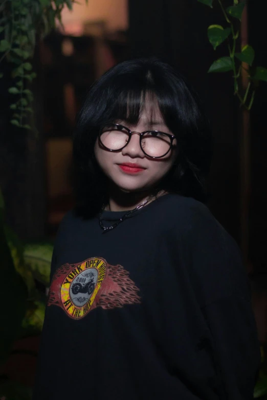 a woman with glasses posing for a picture, an album cover, inspired by Ruth Jên, pexels contest winner, realism, wearing a black t-shirt, ruan cute vtuber, (night), kuntilanak