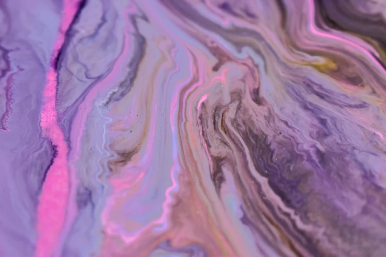 a close up of a piece of marble, by Sophie Pemberton, trending on pexels, abstract art, purple liquid, music video, happy trippy mood, iridescent metals