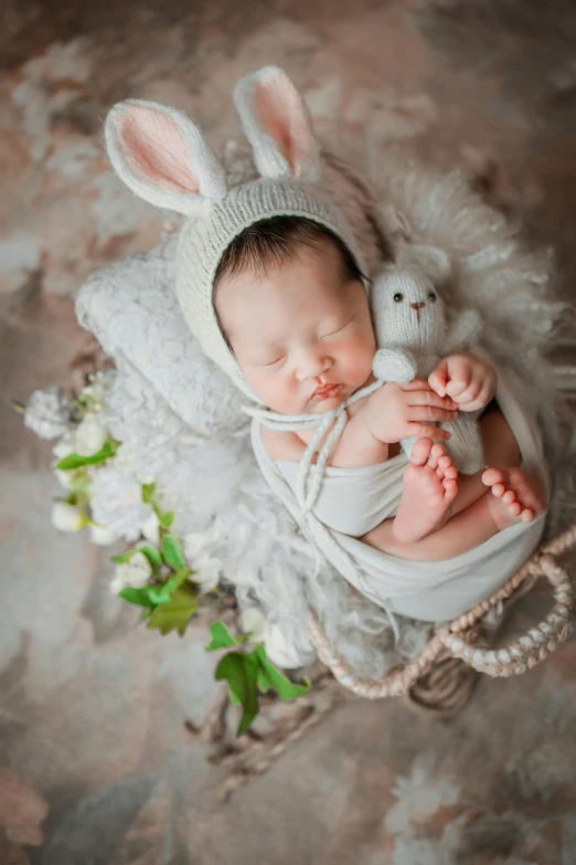 a baby wearing a bunny hat and holding a stuffed animal, renaissance, ethereal and dreamy theme, grey, small, flowers