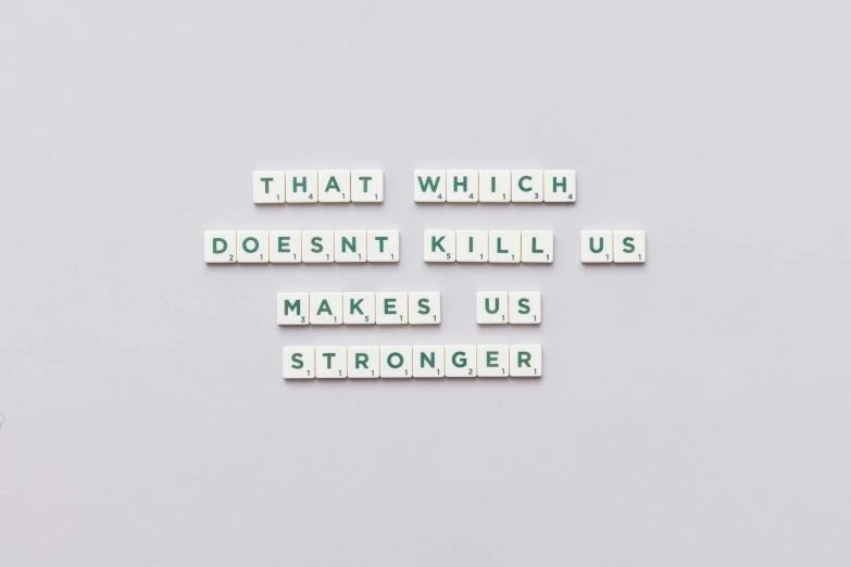 a sign that says that which doesn't kill us makes us stronger, unsplash, international typographic style, steroid use, background image, inspirational artwork, ad image
