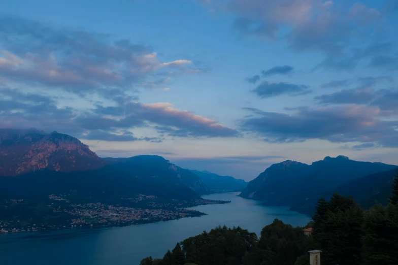 a large body of water surrounded by mountains, by Daniel Lieske, pexels contest winner, renaissance, evening time, vouge italy, lake blue, late summer evening