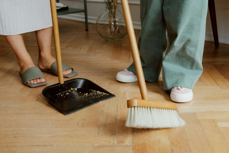 a woman sweeping the floor with a broom, by Julia Pishtar, pexels contest winner, medium shot of two characters, poop, 3 - piece, no - text no - logo