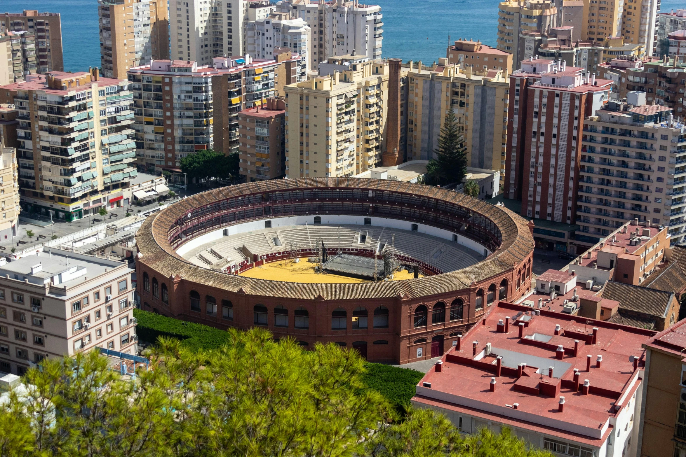 a view of a city from the top of a hill, by Pedro Álvarez Castelló, pexels contest winner, baseball stadium, including a matador & a bull, 2 5 6 x 2 5 6 pixels, mini amphitheatre