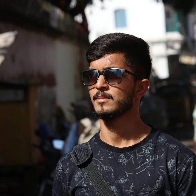 a man wearing sunglasses standing in front of a building, by Saurabh Jethani, lgbtq, portrait image, profile pic, male teenager