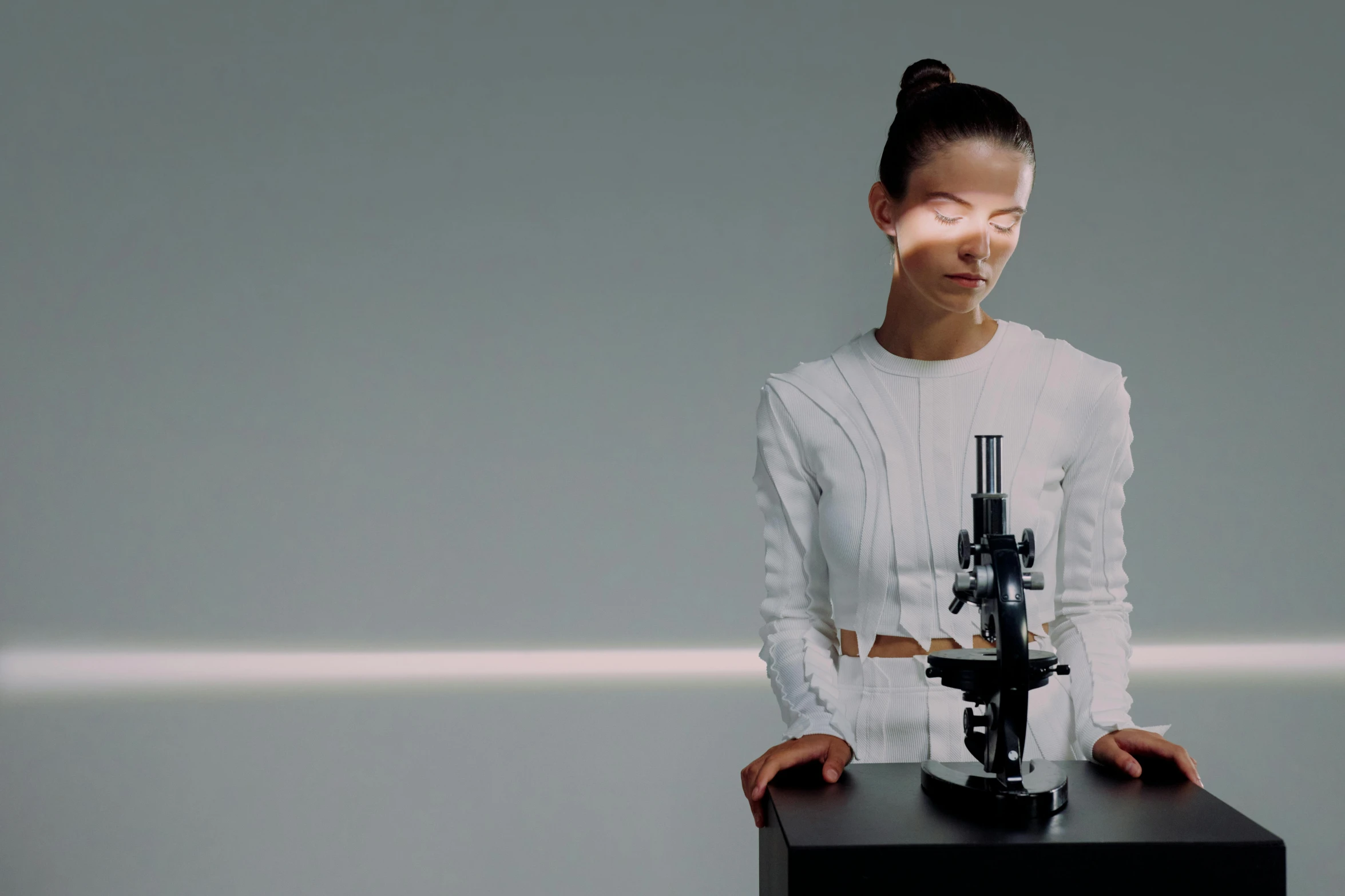 a woman standing in front of a microscope, a hologram, inspired by Anna Füssli, hyperrealism, ex machina, wearing light, mei-ling zhou, on a white table