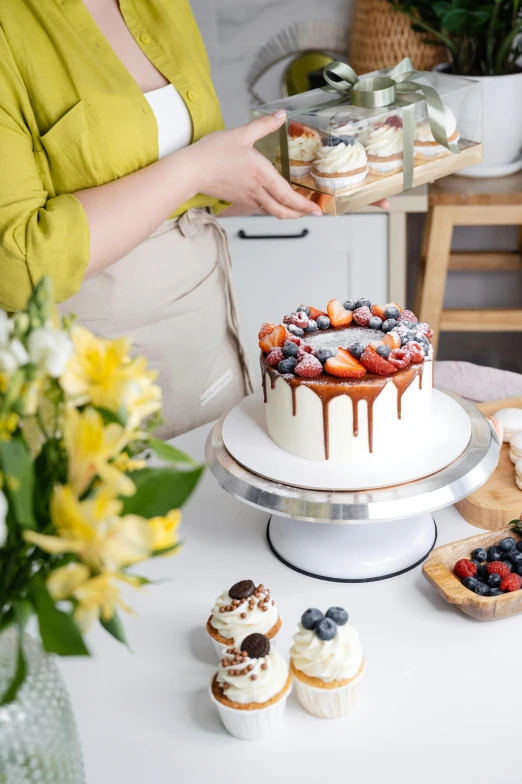 a woman standing in front of a cake on a table, a still life, trending on unsplash, on a white table, fully decorated, bakery, profile image