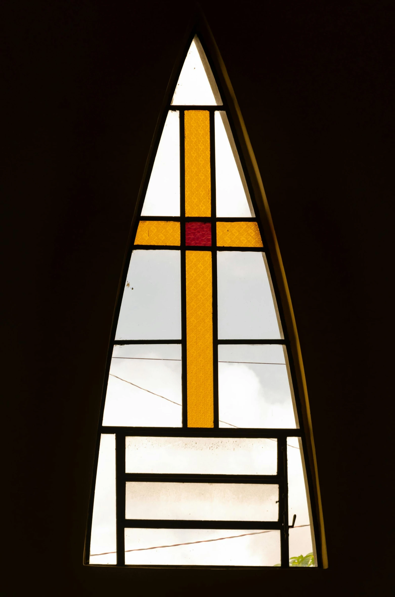 a close up of a stained glass window in a building, by Doug Ohlson, de stijl, faded red and yelow, holy cross, spire, inside large window of ship