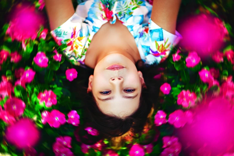 a woman laying on top of a lush green field of flowers, by Julia Pishtar, pexels contest winner, process art, symmetrical beauty face, upside down, laying on roses, paradise garden massage