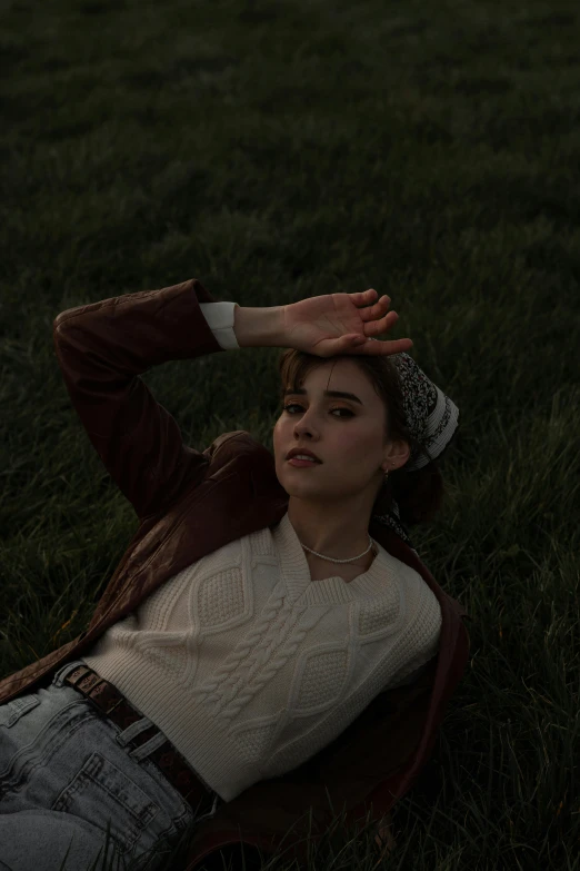 a woman laying on top of a lush green field, an album cover, inspired by Elsa Bleda, trending on pexels, magical realism, portrait androgynous girl, late evening, joey king, thoughtful pose