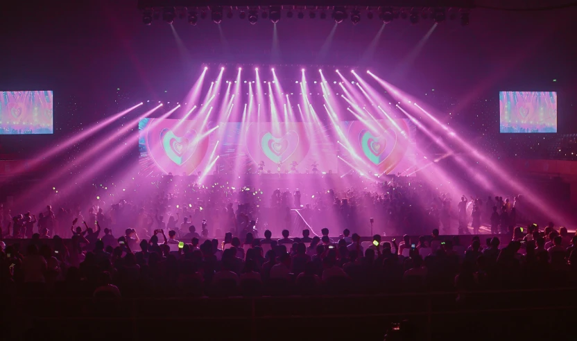 a group of people that are standing in front of a stage, purple laser lighting, beeple |, concert lighting, tournament