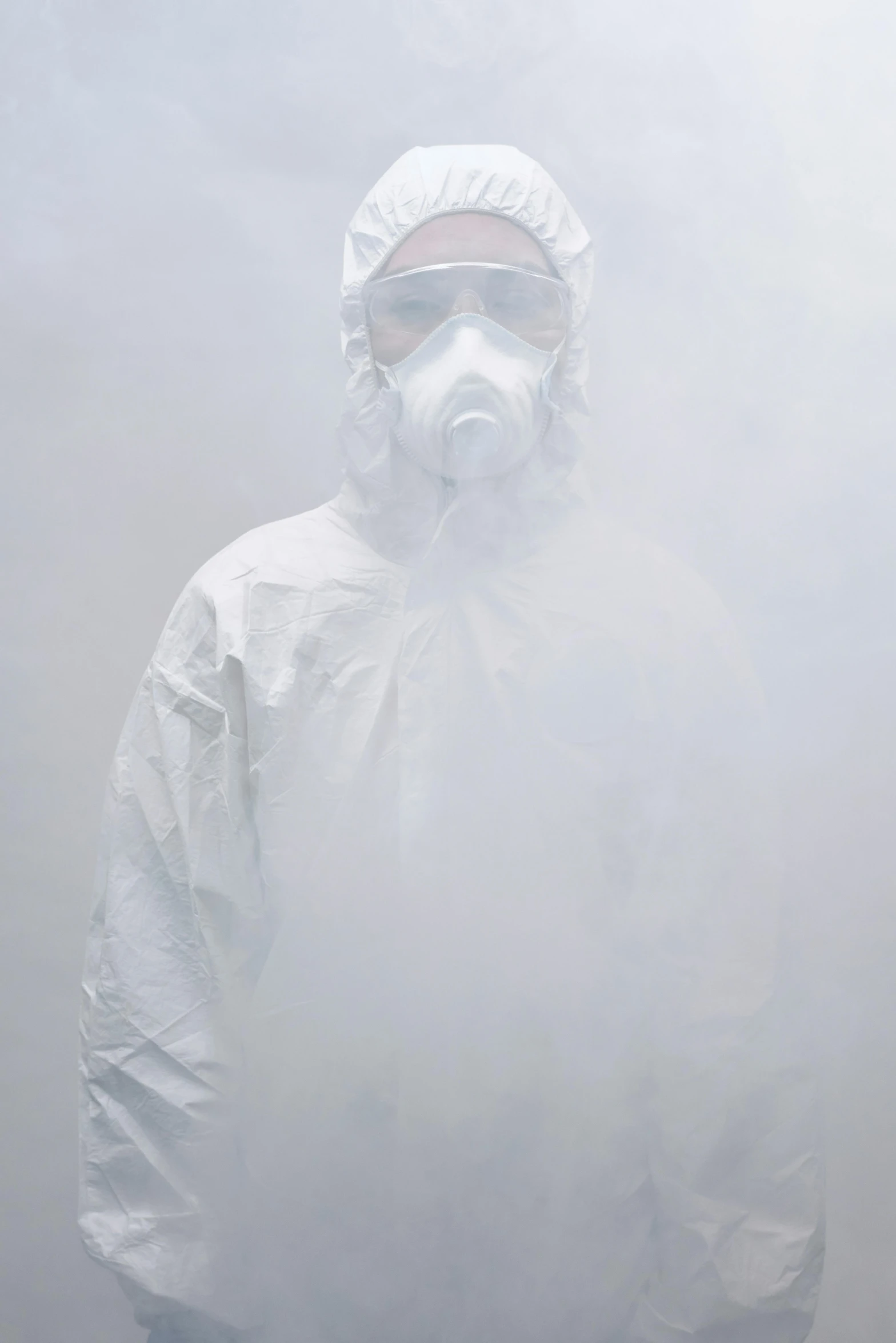 a man wearing a gas mask standing in a foggy area, by Alison Geissler, wearing a white hospital gown, on a gray background, coronavirus, staff wearing hazmat suits