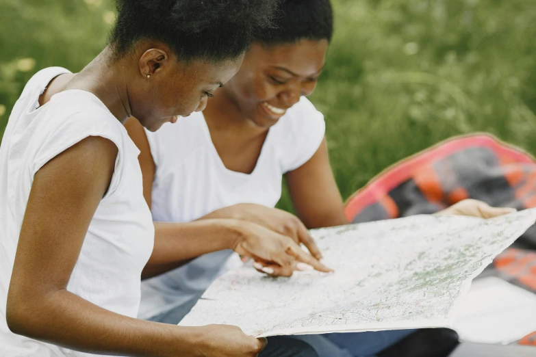 two women sitting on a blanket looking at a map, pexels, photo of a black woman, walking down, pictured from the shoulders up, schools