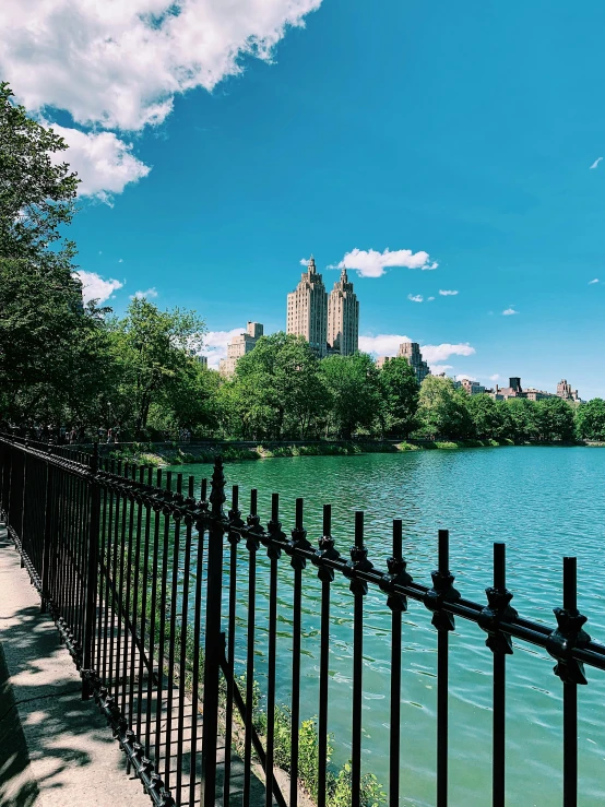 a fence that is next to a body of water, trending on unsplash, art nouveau, central park, gopro photo, 🚿🗝📝, 2 0 0 0's photo