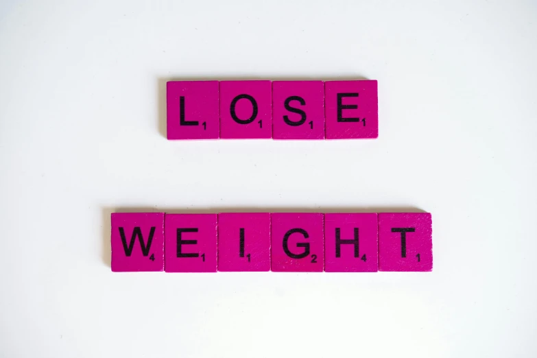 a couple of pink scrabbles sitting on top of each other, by Carey Morris, pexels, smallest waistline ever, is this loss?, light box, fitness