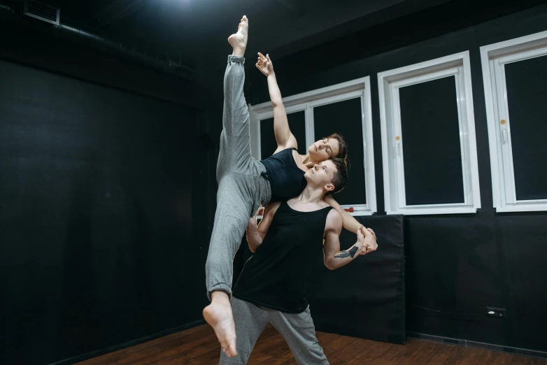 a man and woman doing a handstand in a dance studio, by Emma Andijewska, pexels contest winner, a woman floats in midair, ayanamikodon and irakli nadar, thumbnail, full body 8k