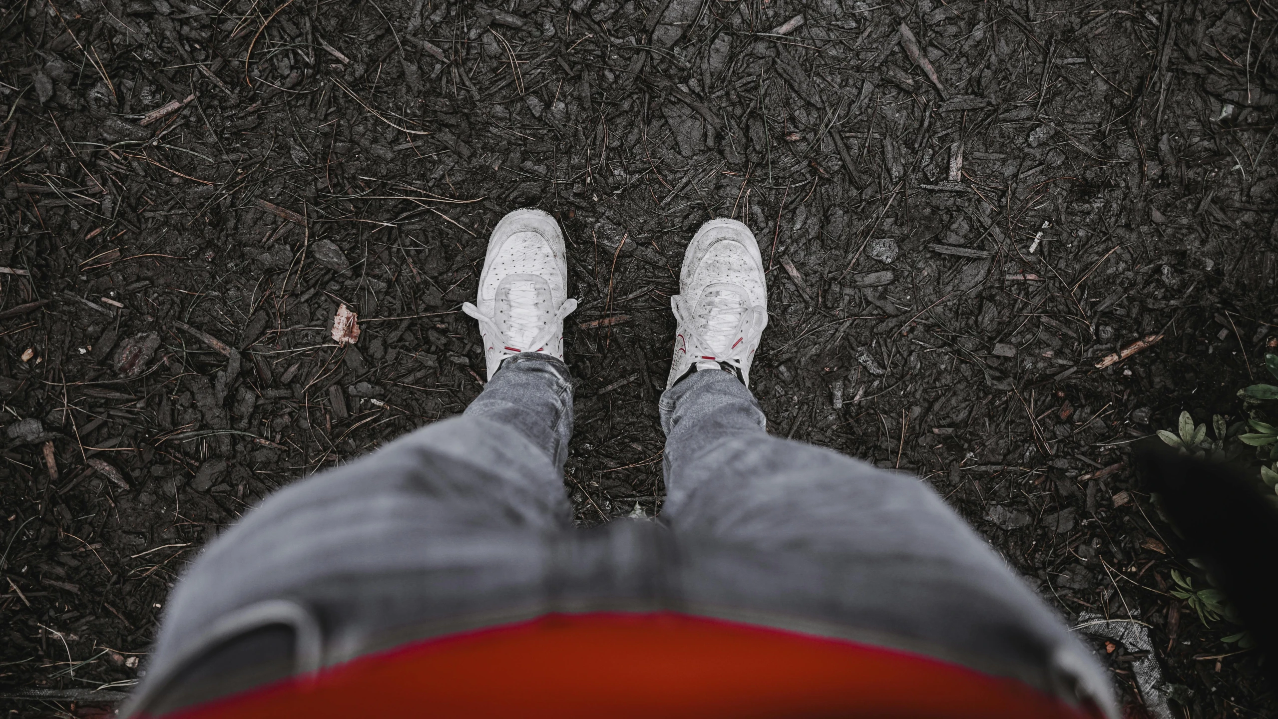 a person standing on the ground with their feet up, by Adam Marczyński, pexels contest winner, realism, orange grey white, fear of god style, white clothes, red and grey only