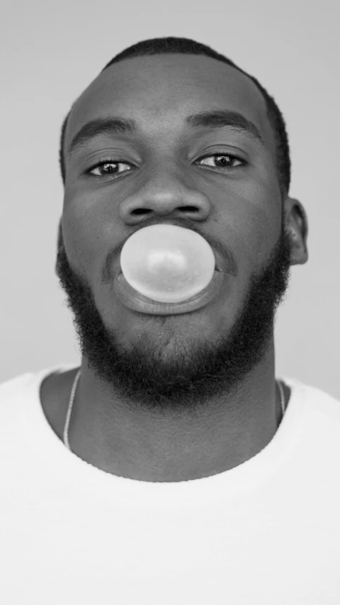 a man with a bubble in his mouth, a black and white photo, inspired by Xanthus Russell Smith, pexels, made of lollypops, discord profile picture, mkbhd, pewdiepie