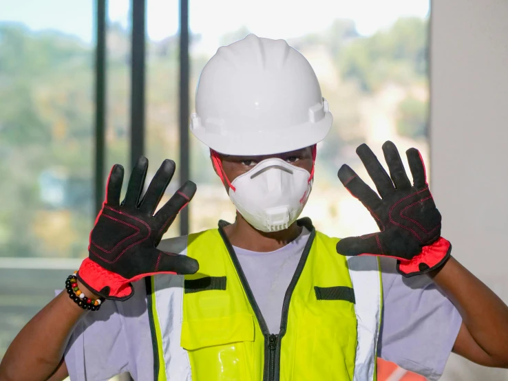 a construction worker with his hands in the air, by Afewerk Tekle, pexels contest winner, plasticien, balaclava mask, white and red body armor, bright construction materials, healthcare worker