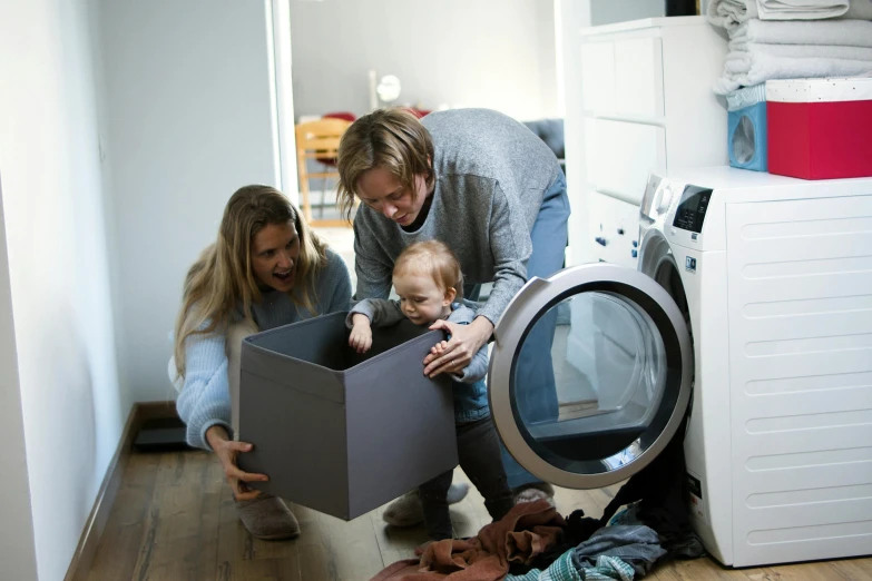 a woman and a child in front of a washing machine, a picture, by Matthias Stom, pexels contest winner, parents watching, inspect in inventory image, grey, thumbnail