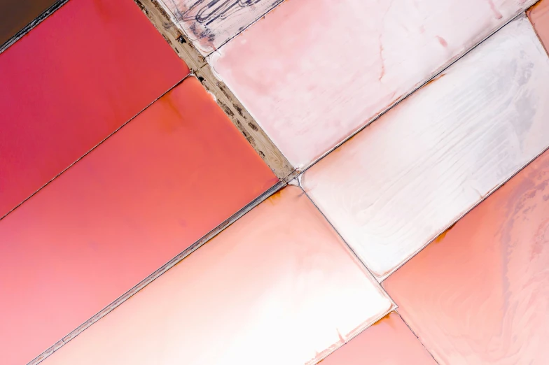 a man riding a skateboard on top of a tiled floor, inspired by Christo, trending on unsplash, color field, covered in pink flesh, seen from a plane, metal panels, pale red