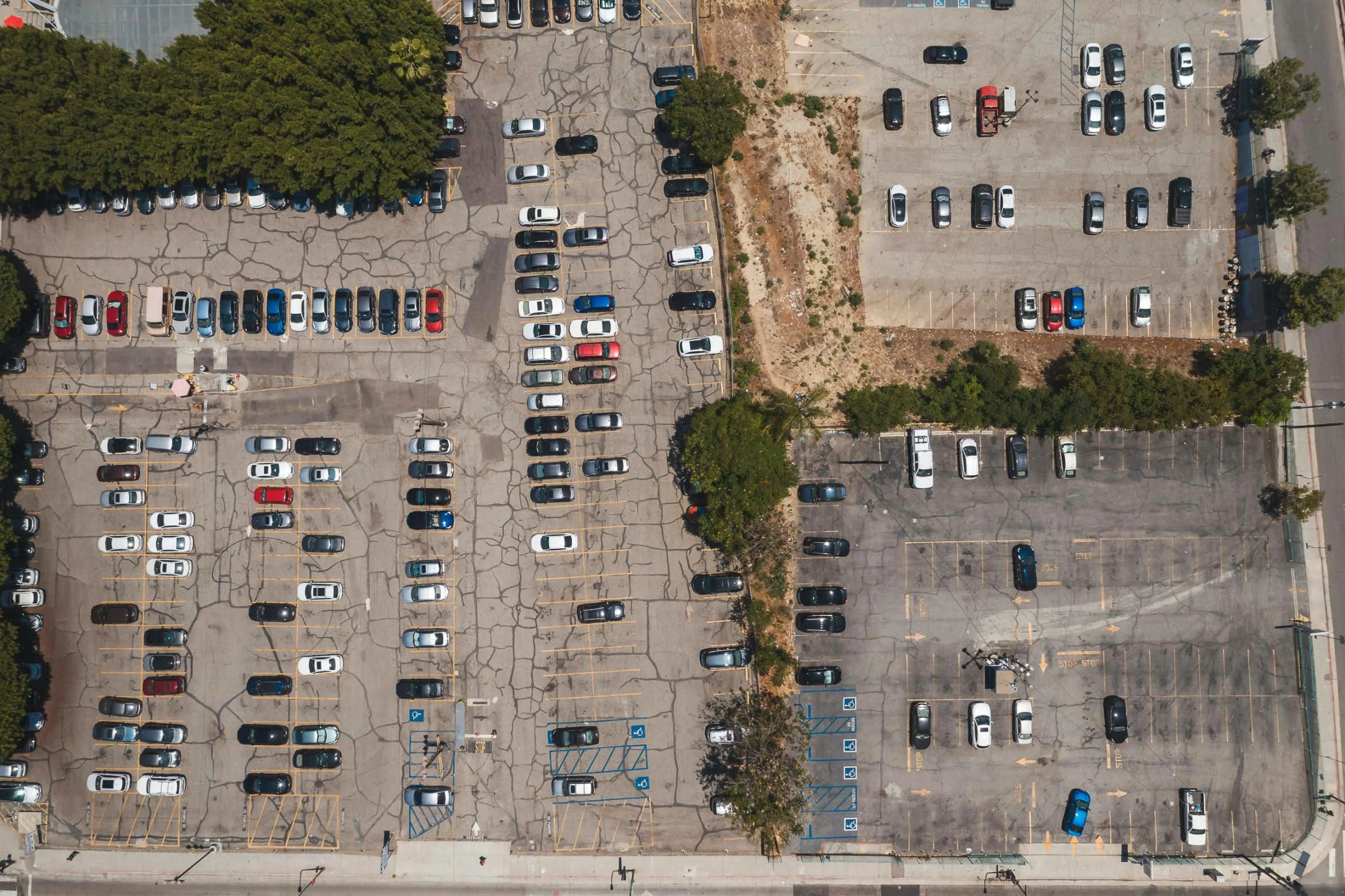 a parking lot filled with lots of parked cars, by Carey Morris, unsplash, photorealism, square, satellite imagery, california, abandoned vehicles