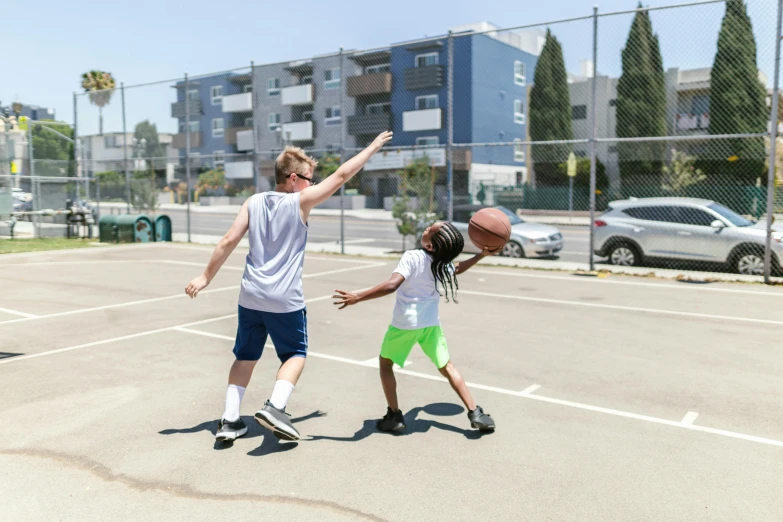 a couple of kids playing a game of basketball, by Gavin Hamilton, unsplash, los angelos, low quality photo, athletic crossfit build, summer day