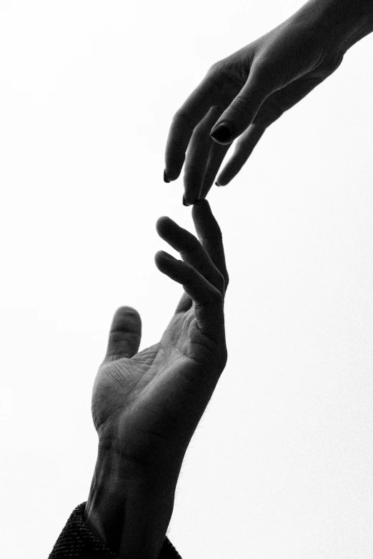 a black and white photo of two hands reaching for each other, by Alexis Grimou, unsplash, ffffound, the lovers, high key, ascending