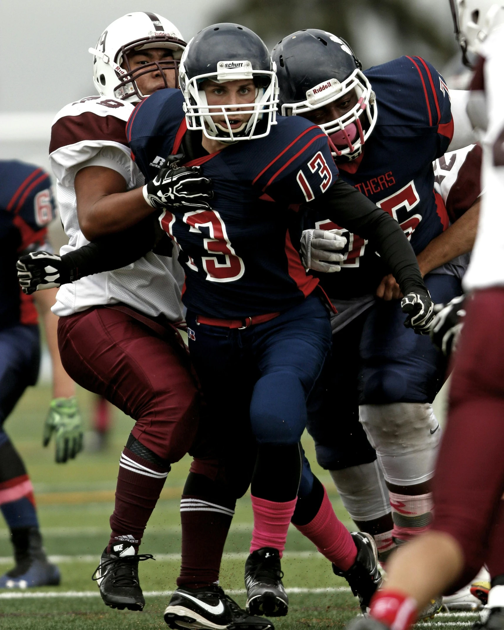 a group of young men playing a game of football, a digital rendering, pexels contest winner, vancouver school, menacing look, transgender, full uniform, in 2 0 1 5