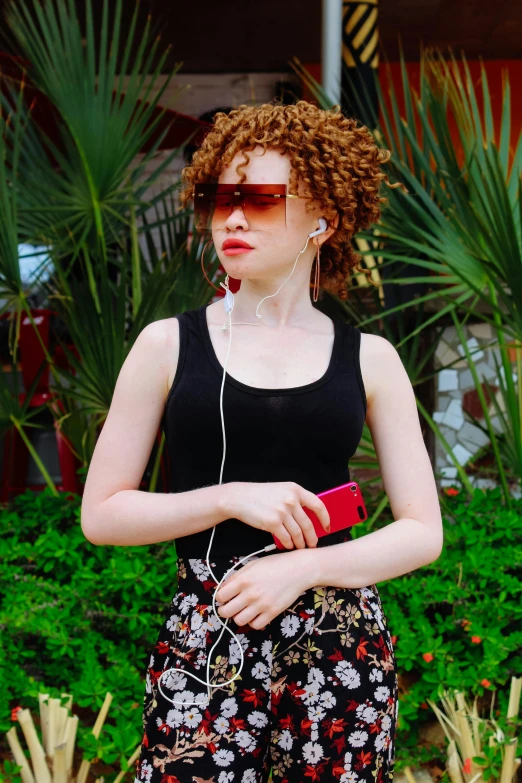 a woman in a black tank top and floral pants, pexels contest winner, red curly hair, in style of lam manh, full body:: sunny weather::, avatar image