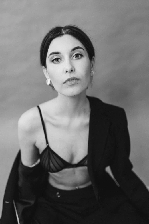 a black and white photo of a woman in a suit, a black and white photo, by Maurycy Gottlieb, unsplash, arabesque, portrait of ana de armas, in a black betch bra, georgia o'keefe, 2 0 0 0 s