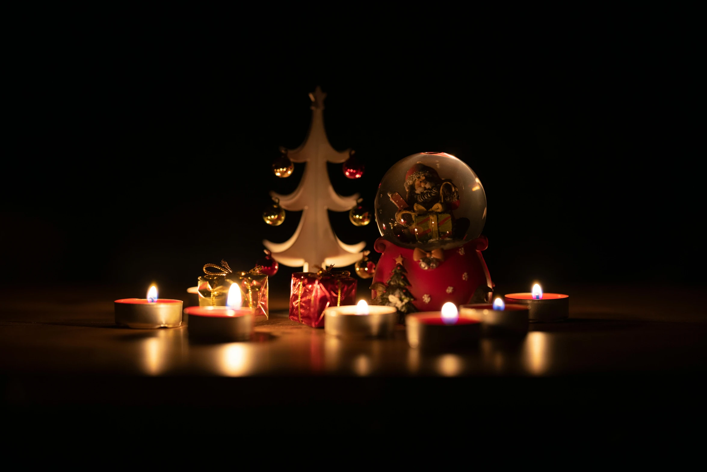 a group of candles sitting on top of a table, a still life, pexels, figuration libre, snowglobe, profile image, dim lit, toy photography