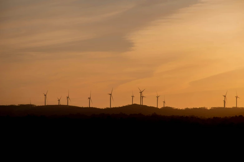 a group of wind turbines sitting on top of a hill, by Jesper Knudsen, pexels contest winner, hurufiyya, sunset panorama, subtle, 15081959 21121991 01012000 4k, viewed from a distance