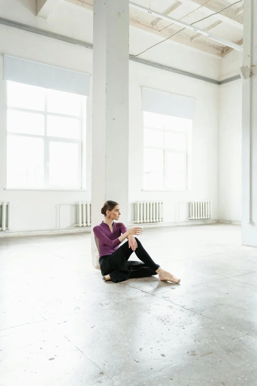 a woman sitting on the floor in an empty room, by Nina Hamnett, trending on unsplash, ballet, programming, multiple stories, anna nikonova aka newmilky