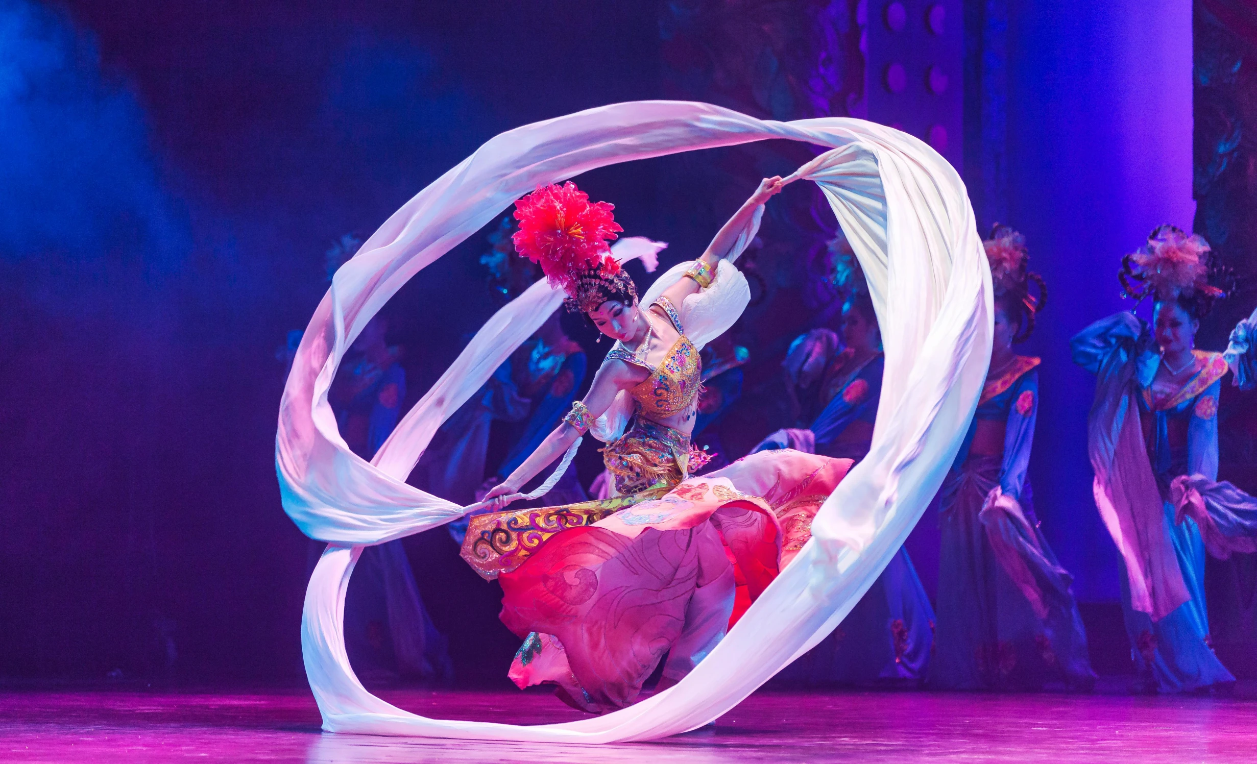 a group of people standing on top of a stage, arabesque, swirling fabric, aladdin, beijing, a woman floats in midair