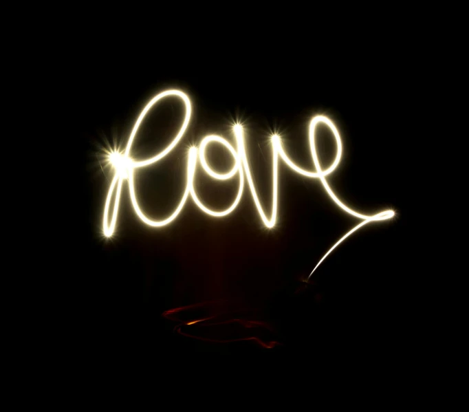 a light painting of the word love in the dark, a picture, by Joe Bowler, pexels, ✨🕌🌙, handheld, love craft, - signature