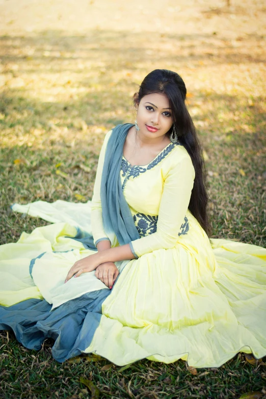 a woman in a yellow and blue dress sitting on the grass, assamese, uploaded, icon, 2 0 yo