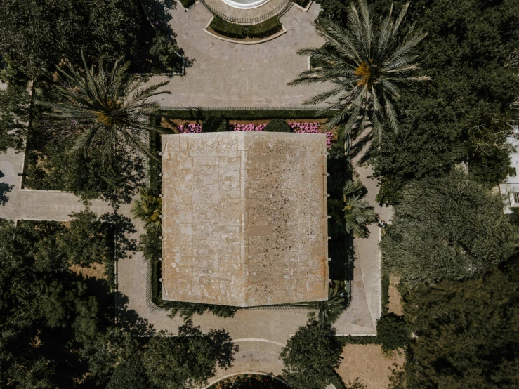 a clock that is on the side of a building, an album cover, inspired by Tomàs Barceló, pexels contest winner, baroque, aerial shot from the drone, archways made of lush greenery, john pawson, cyprus