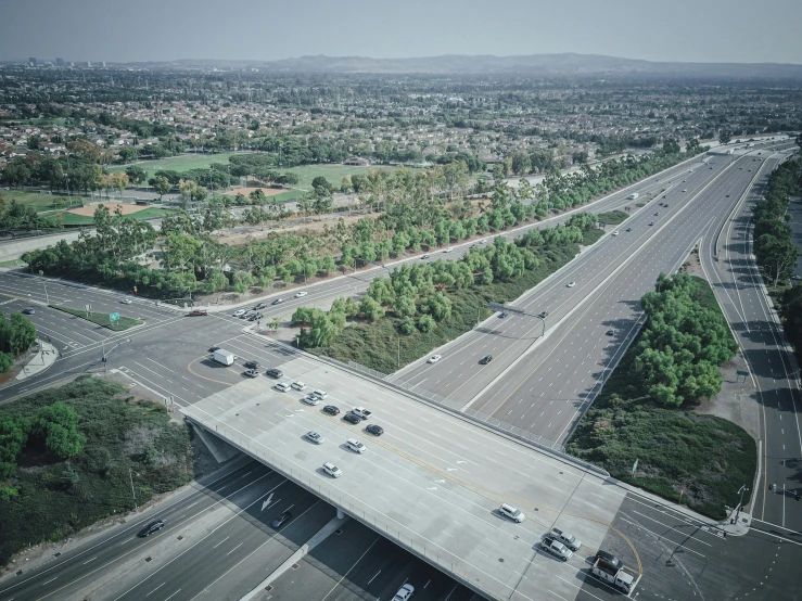 an aerial view of a highway with cars driving on it, unsplash, photorealism, 1600 south azusa avenue, broken bridges, 2000s photo, 4k/8k