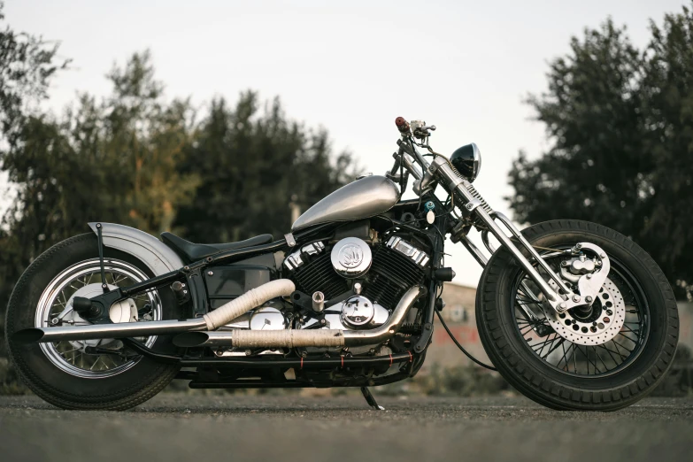 a motorcycle parked on the side of the road, a portrait, unsplash, photorealism, california;, made from mechanical parts, full front view, three quarter profile