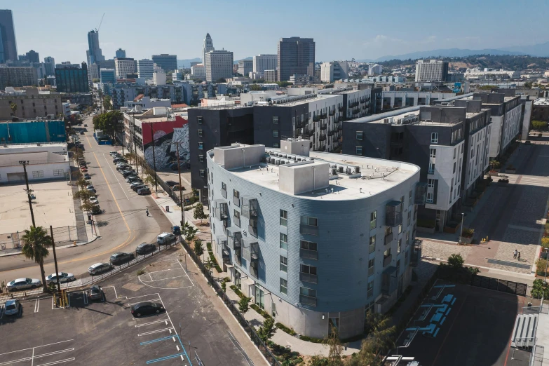 an aerial view of a city with tall buildings, a portrait, by Matt Cavotta, unsplash, 1600 south azusa avenue, concrete housing, bjarke ingels, seen from outside